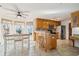 Bright eat-in kitchen with updated appliances, tile floors, an island with seating, and natural light at 5429 Roxbury Dr, North Charleston, SC 29418