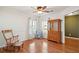 Bright living room with hardwood floors, a ceiling fan, and natural light through large windows at 5429 Roxbury Dr, North Charleston, SC 29418