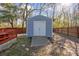 Backyard storage shed with a concrete ramp and a set of white double doors at 5429 Roxbury Dr, North Charleston, SC 29418