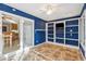 Spacious sunroom with tile flooring, built in shelving and views to the kitchen at 5429 Roxbury Dr, North Charleston, SC 29418