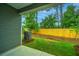 View of a well-maintained backyard with green grass, mulch, and a wooden fence at 604 Twin Rivers Dr, Wando, SC 29492