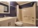 A bathroom with blue walls, white sink, toilet, and shower with white bath tub at 6211 Rolling Fork Rd. # 1504 Apt D, North Charleston, SC 29406