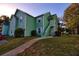 Two-story condo building with green siding and grass lawn at 6211 Rolling Fork Rd. # 1504 Apt D, North Charleston, SC 29406