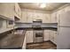 Well-lit kitchen with white cabinetry, stainless steel appliances, and dark countertops at 6211 Rolling Fork Rd. # 1504 Apt D, North Charleston, SC 29406