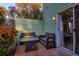 A patio area with a small table and two benches, with a sliding glass door into the home at 6211 Rolling Fork Rd. # 1504 Apt D, North Charleston, SC 29406