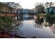 Scenic pond view with a fountain and charming homes reflected in the water at 6211 Rolling Fork Rd. # 1504 Apt D, North Charleston, SC 29406