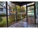 View from a screened in porch of green grass, trees, bushes, and an outdoor seating area at 6211 Rolling Fork Rd. # 1504 Apt D, North Charleston, SC 29406