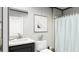 Clean bathroom with a white sink, marble countertop, and a patterned shower curtain at 626 Dennis Ridge Rd, Bonneau, SC 29431