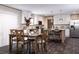 This dining area and kitchen features stainless steel appliances, white cabinets, an island, and dark wood floors at 632 Dennis Ridge Rd, Bonneau, SC 29431