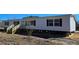 Charming single-story home featuring vinyl siding, black window shutters, and a new wooden staircase and porch at 632 Dennis Ridge Rd, Bonneau, SC 29431
