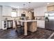 This kitchen features stainless steel appliances, white cabinets, an island and dark wood floors at 632 Dennis Ridge Rd, Bonneau, SC 29431