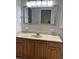 Bathroom vanity with updated mirror, lighting, and countertop and a large mirror at 827 Duck Hawk Retreat, Charleston, SC 29412