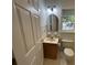 Bathroom with an updated vanity, mirror, lighting, and window, beside a closed white door at 827 Duck Hawk Retreat, Charleston, SC 29412