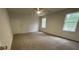 Bedroom with carpet, a ceiling fan, and two windows providing natural light and views to the outside at 827 Duck Hawk Retreat, Charleston, SC 29412