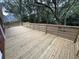 The spacious wooden deck features a fence and overlooks the landscaped backyard at 827 Duck Hawk Retreat, Charleston, SC 29412