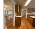Open kitchen showcasing wood cabinets, hardwood floors, and seamless transition to other rooms at 827 Duck Hawk Retreat, Charleston, SC 29412
