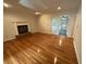 Bright living room featuring hardwood floors, a fireplace, and a door to the porch at 827 Duck Hawk Retreat, Charleston, SC 29412