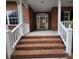 Inviting front porch with brick steps, white railings, and a decorative glass front door at 827 Duck Hawk Retreat, Charleston, SC 29412