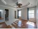 Bedroom with tray ceilings, fan, and flooring being installed at 8396 Waltham Rd, North Charleston, SC 29406