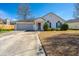 Charming single-story home with a well-maintained lawn and attached two car garage at 8396 Waltham Rd, North Charleston, SC 29406
