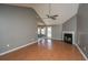 Bright living room with a fireplace, ceiling fan, and wood laminate flooring at 8396 Waltham Rd, North Charleston, SC 29406