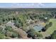 An aerial view of the community, featuring lush greenery, swimming pool, golf course, and tennis courts at 8757 E Fairway Woods Dr, North Charleston, SC 29420