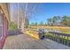 Spacious wooden back deck with grill and outdoor seating overlooking the tranquil lake at 8757 E Fairway Woods Dr, North Charleston, SC 29420