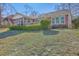 Exterior view of the back of a red brick home with a screened in porch, and wooden deck at 8757 E Fairway Woods Dr, North Charleston, SC 29420