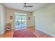 Bright bedroom with a ceiling fan, natural light, and sliding glass doors to the outdoor patio at 8757 E Fairway Woods Dr, North Charleston, SC 29420