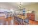 Inviting dining area featuring a wood table, seating for six, and seamless flow into the open-concept kitchen at 8757 E Fairway Woods Dr, North Charleston, SC 29420