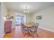 Cozy dining room with a wooden table, chairs, and view into sun room at 8757 E Fairway Woods Dr, North Charleston, SC 29420