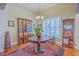 Dining room featuring a round table, hardwood floors, and built-in display cabinets at 8757 E Fairway Woods Dr, North Charleston, SC 29420