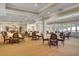Elegant dining room with tables set and view of outdoor scenery for social gatherings at 8757 E Fairway Woods Dr, North Charleston, SC 29420