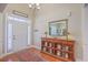 Bright foyer featuring a wooden console table, hardwood floors, and a decorative mirror at 8757 E Fairway Woods Dr, North Charleston, SC 29420