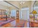 Elegant foyer with high ceilings, hardwood floors, and decorative furnishings at 8757 E Fairway Woods Dr, North Charleston, SC 29420