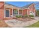 Inviting front porch of a brick home, featuring decorative plants and charming architectural details at 8757 E Fairway Woods Dr, North Charleston, SC 29420
