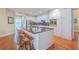 Modern kitchen with a large island, seating, stainless steel appliances, and stylish cabinetry at 8757 E Fairway Woods Dr, North Charleston, SC 29420