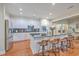 Bright kitchen features an island with seating, stainless appliances, and view into the living room at 8757 E Fairway Woods Dr, North Charleston, SC 29420