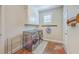 Functional laundry room with modern washer/dryer, storage shelves, and convenient access to the home at 8757 E Fairway Woods Dr, North Charleston, SC 29420