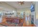 Spacious living room featuring hardwood floors, fireplace, and open access to the kitchen at 8757 E Fairway Woods Dr, North Charleston, SC 29420