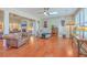 Open living space filled with natural light, hardwood floors, and views into other rooms at 8757 E Fairway Woods Dr, North Charleston, SC 29420