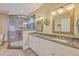 Luxurious main bathroom with granite countertops, dual sinks, and a frameless glass shower at 8757 E Fairway Woods Dr, North Charleston, SC 29420
