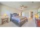 Comfortable main bedroom with ceiling fan, natural light and access to bathroom at 8757 E Fairway Woods Dr, North Charleston, SC 29420