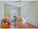 Bright home office features a vaulted ceiling, hardwood floors, and shuttered arched window at 8757 E Fairway Woods Dr, North Charleston, SC 29420