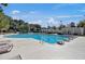 The community pool with lounge chairs and umbrellas offers a refreshing oasis for residents to unwind and socialize at 8757 E Fairway Woods Dr, North Charleston, SC 29420
