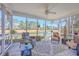 Relaxing screened porch with wicker furniture and decor overlooking the tranquil water at 8757 E Fairway Woods Dr, North Charleston, SC 29420