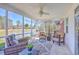 Inviting screened porch features comfortable seating with picturesque lake views at 8757 E Fairway Woods Dr, North Charleston, SC 29420