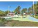 Community splash pad with colorful play equipment offers a fun and safe water play area for children at 8757 E Fairway Woods Dr, North Charleston, SC 29420