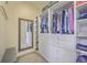 Organized walk-in closet featuring custom shelves, drawers, hanging racks, and full length mirror at 8757 E Fairway Woods Dr, North Charleston, SC 29420