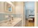 Bathroom with blue tile, large mirror, and vanity adjacent to a bedroom at 927 Preston Rd, Charleston, SC 29412